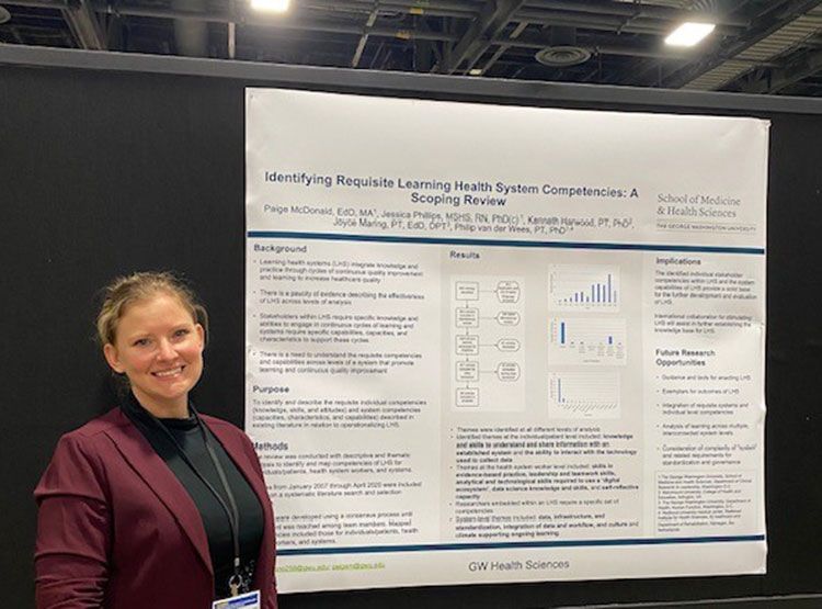 Jessica Phillips standing with her presentation poster