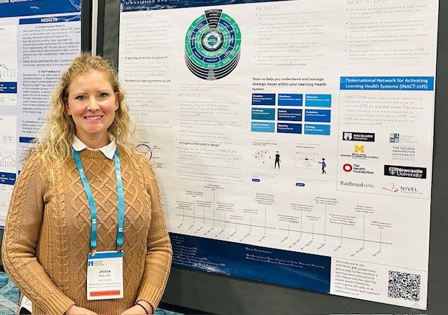 Jessica Phillips standing with her presentation poster
