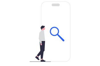 Man standing next to a large phone with a magnifying glass in the center